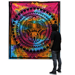 Man stood viewing Hamsa multicolour double bedspread and wall hanging