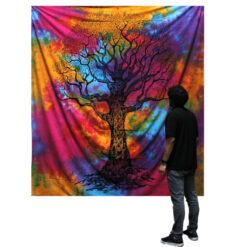 Man stood viewing Winter Tree multicolour double bedspread and wall hanging