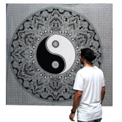 Man stood viewing Yin and Yang black and white double bedspread and wall hanging
