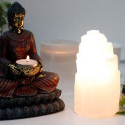 15cm selenite tower lamp next to buddha tealight holder