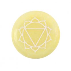 Solar plexus chakra round yellow meditation stone close up